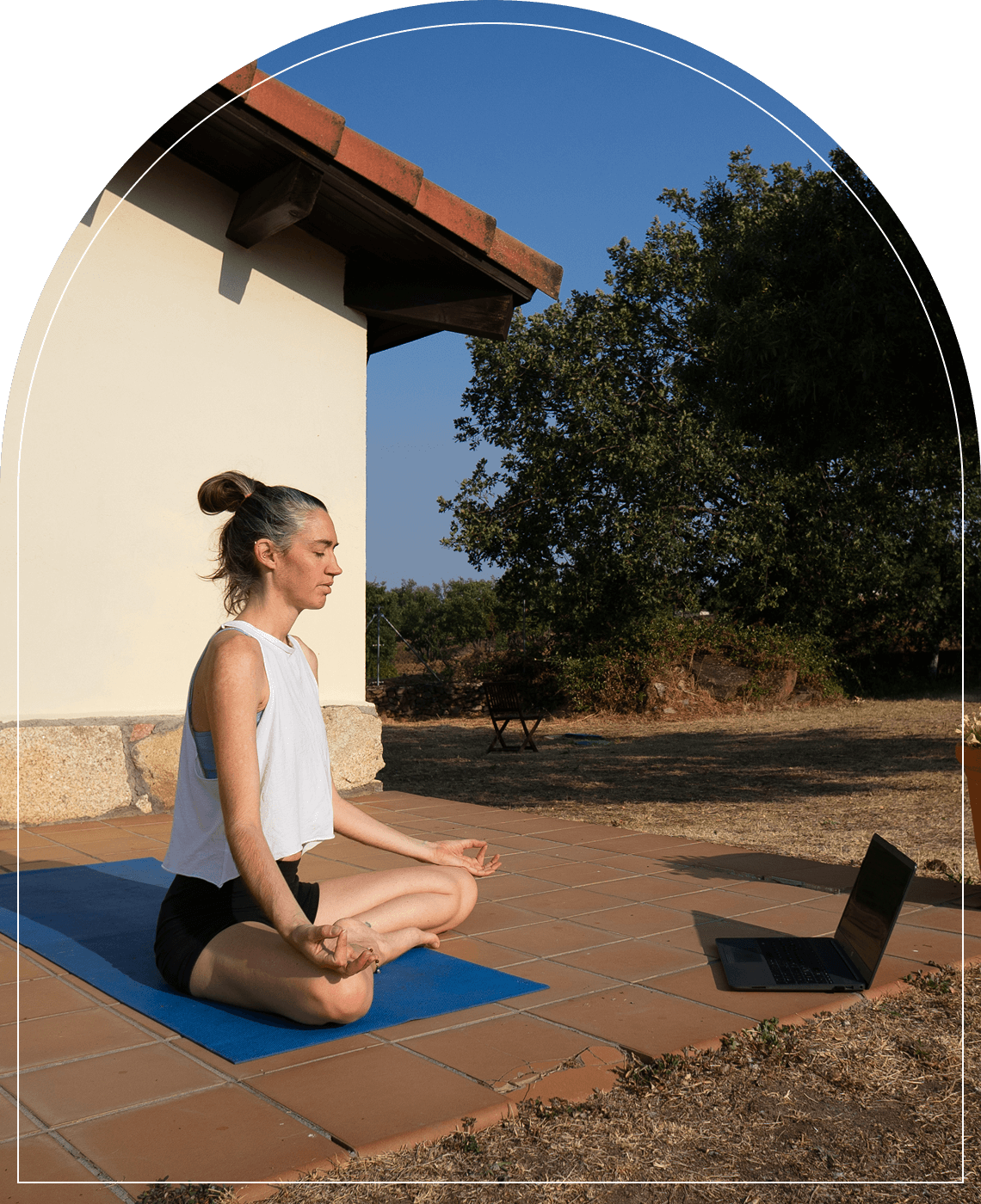 Yoga session on patio with laptop